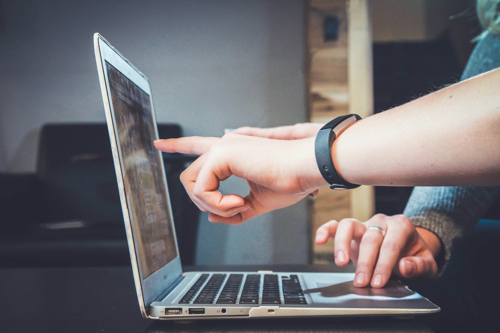 Hands working on a laptop during a digital learning session.